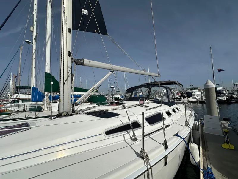 Slide: The Image of 2008 Hunter 38 sailboat docked at marina under clear sky. - 7