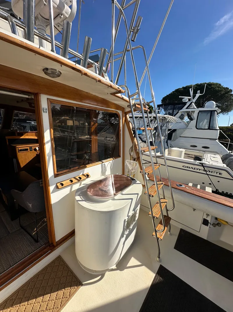 Slide: The Image of 1985 Egg Harbor 33 Sedan boat deck with ladder and seating area. - 10