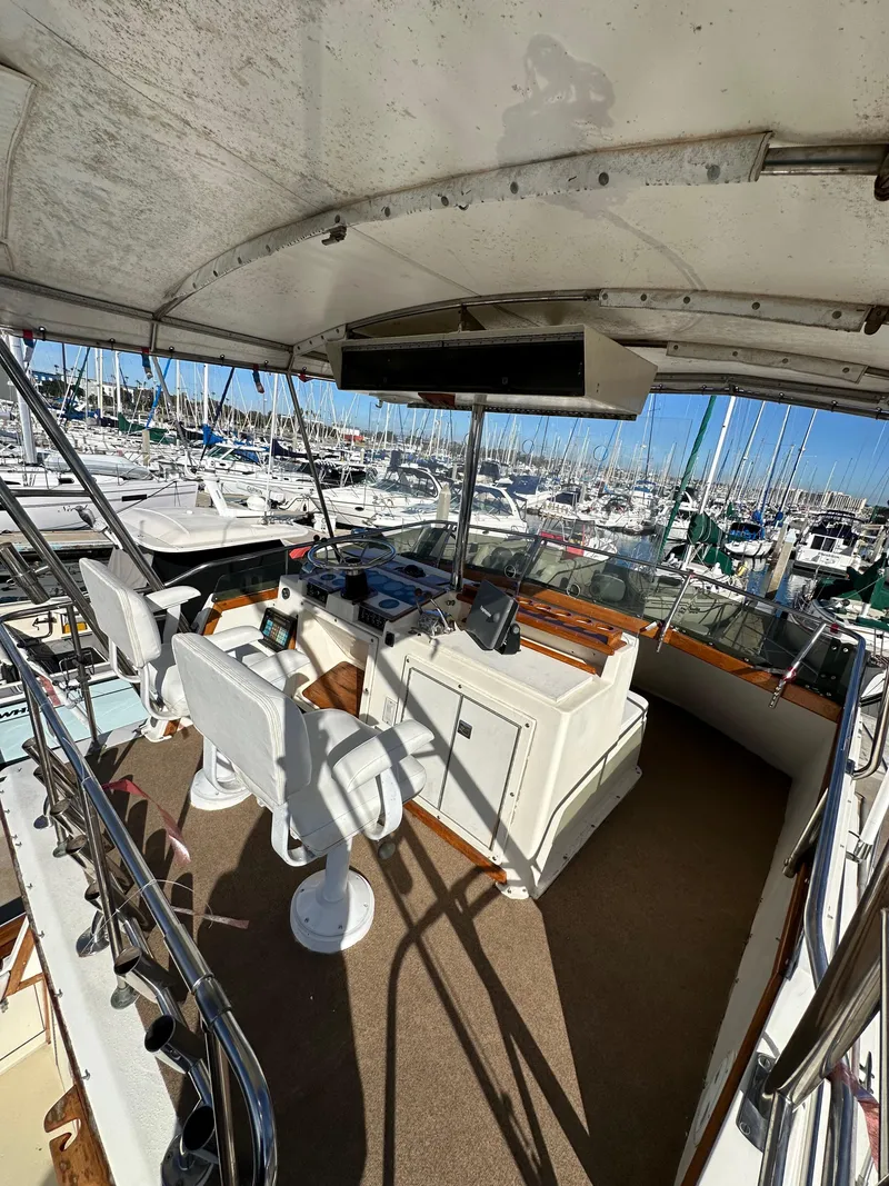 Slide: The Image of 1985 Egg Harbor 33 Sedan boat interior with helm, marina view. - 11