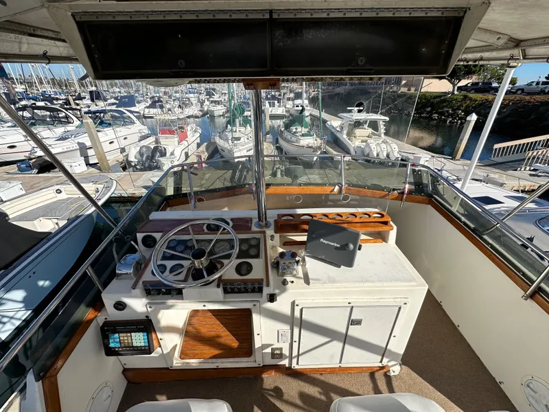 Slide: The Image of 1985 Egg Harbor 33 Sedan boat helm with marina view. - 12