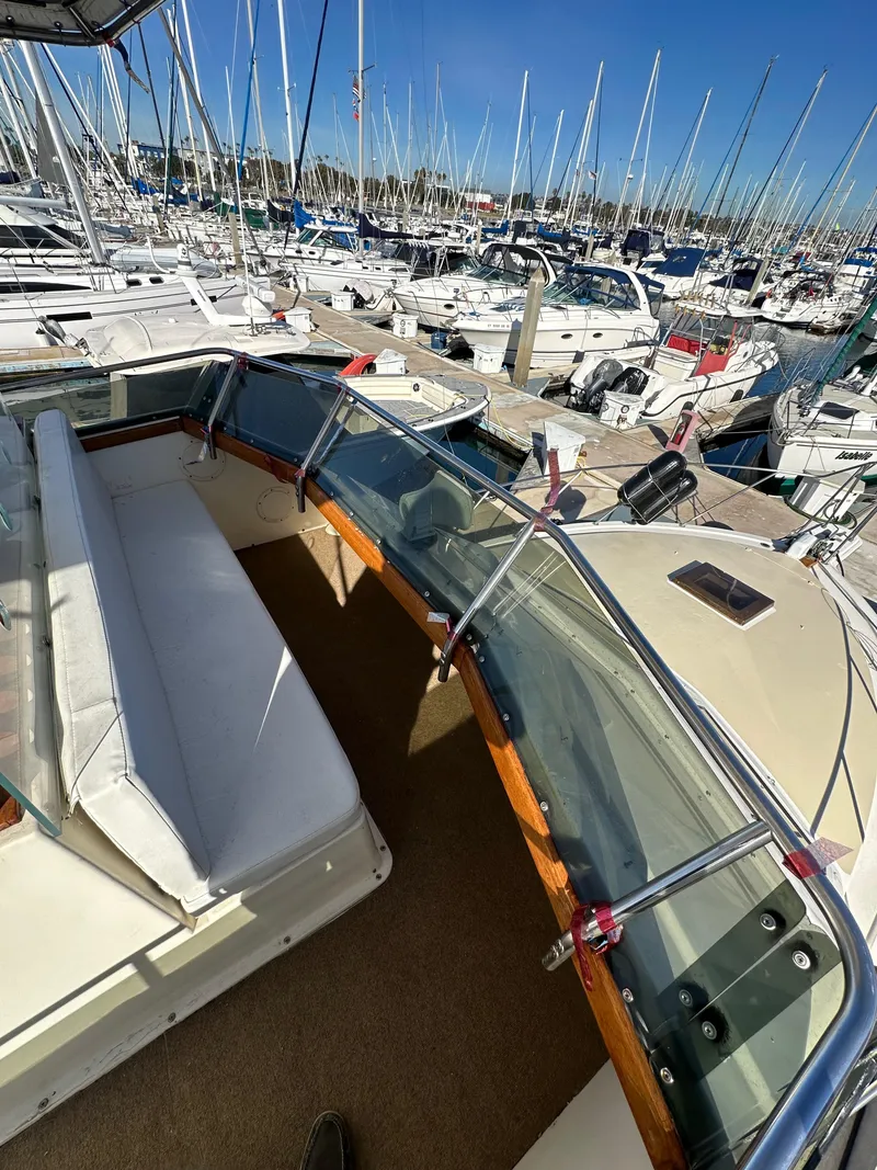 Slide: The Image of 1985 Egg Harbor 33 Sedan boat docked in a marina with sailboats. - 14