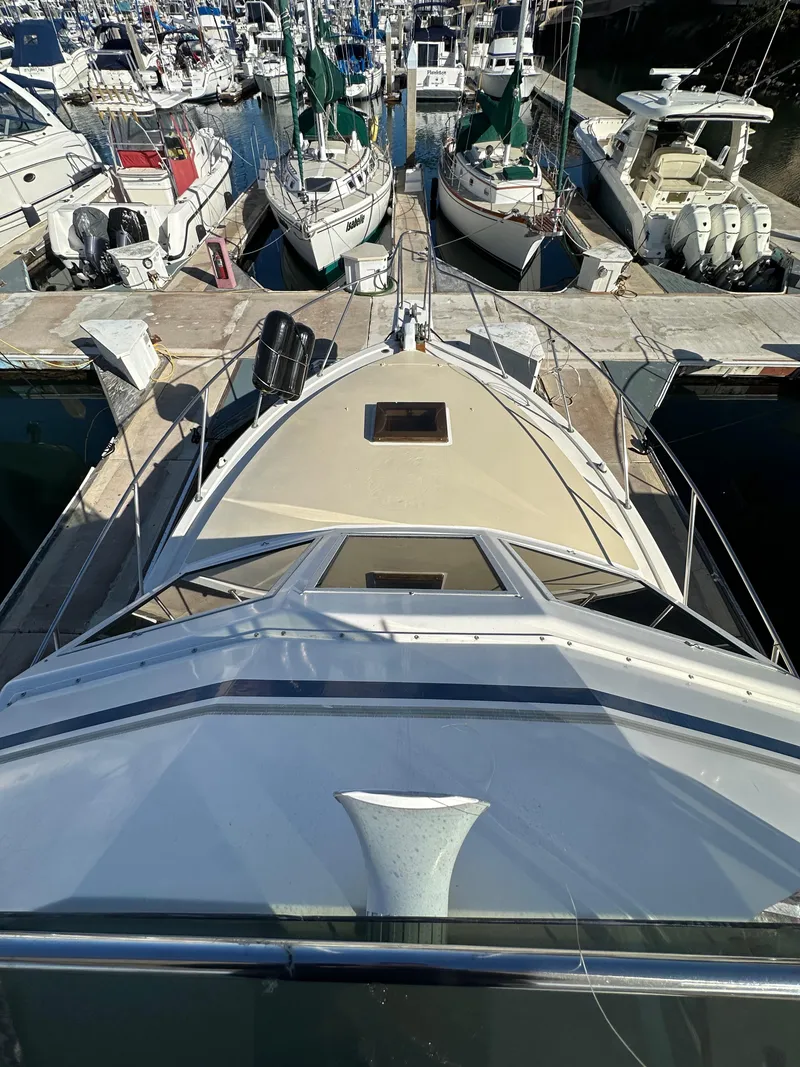 Slide: The Image of 1985 Egg Harbor 33 Sedan yacht docked at marina, surrounded by other boats. - 15