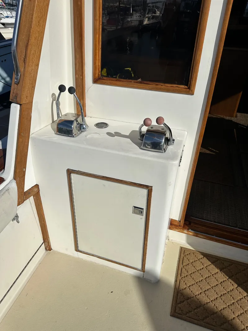 Slide: The Image of 1985 Egg Harbor 33 Sedan boat controls and cabin entrance. - 19