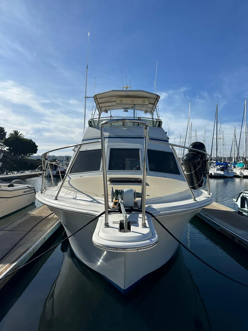 Slide: The Image of 1985 Egg Harbor 33 Sedan yacht docked at marina under clear blue sky. - 2
