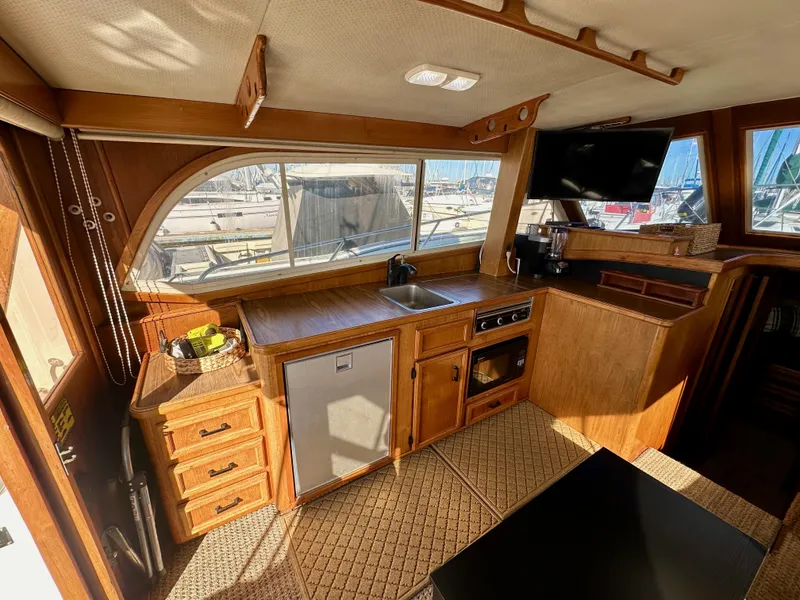 Slide: The Image of Interior of 1985 Egg Harbor 33 Sedan yacht with wooden cabinetry and modern amenities. - 23
