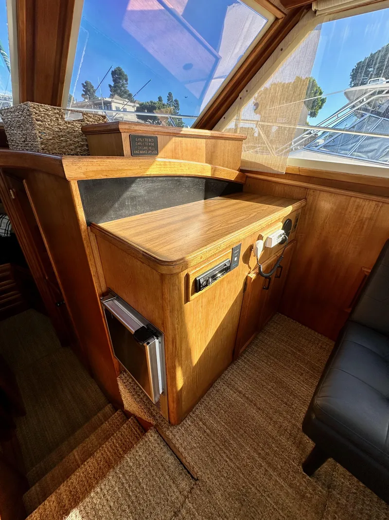 Slide: The Image of 1985 Egg Harbor 33 Sedan interior with wooden helm station and large windows. - 26