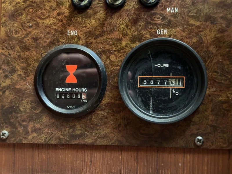 Slide: The Image of Engine and generator hour meters on 1985 Egg Harbor 33 Sedan boat dashboard. - 28