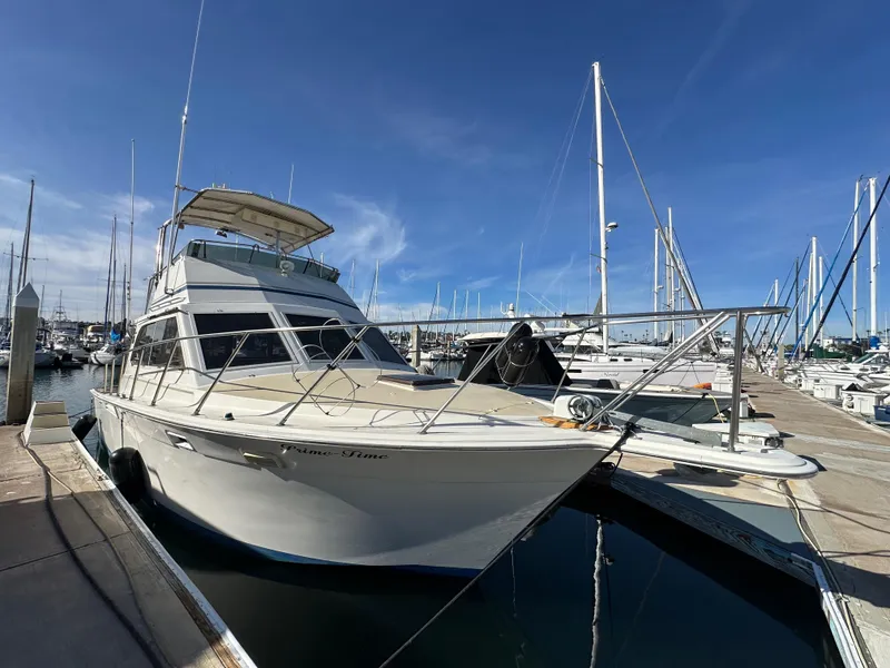 Slide: The Image of 1985 Egg Harbor 33 Sedan yacht docked in marina under clear blue sky. - 3