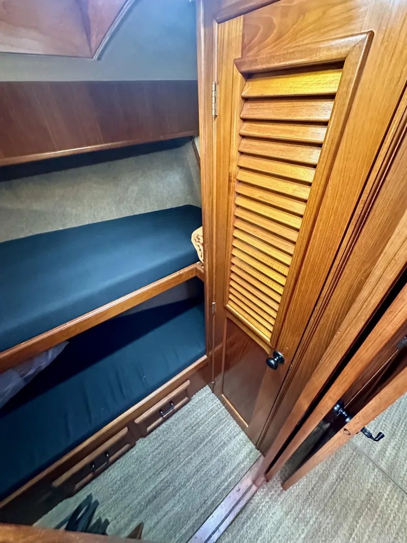 Slide: The Image of 1985 Egg Harbor 33 Sedan cabin interior with wooden finishes and bunk beds. - 34
