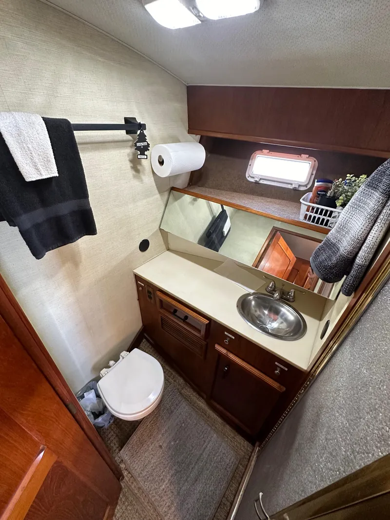 Slide: The Image of 1985 Egg Harbor 33 Sedan bathroom with sink, mirror, and toilet. - 35