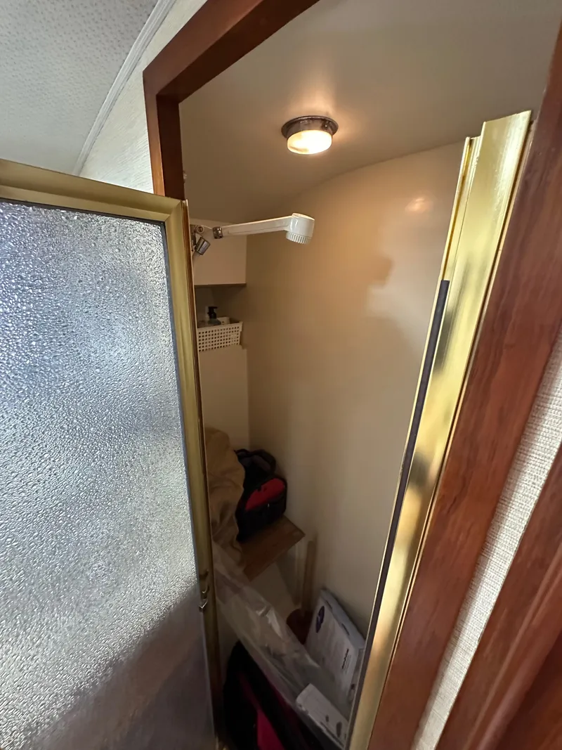 Slide: The Image of Shower area inside 1985 Egg Harbor 33 Sedan boat with frosted glass door. - 36