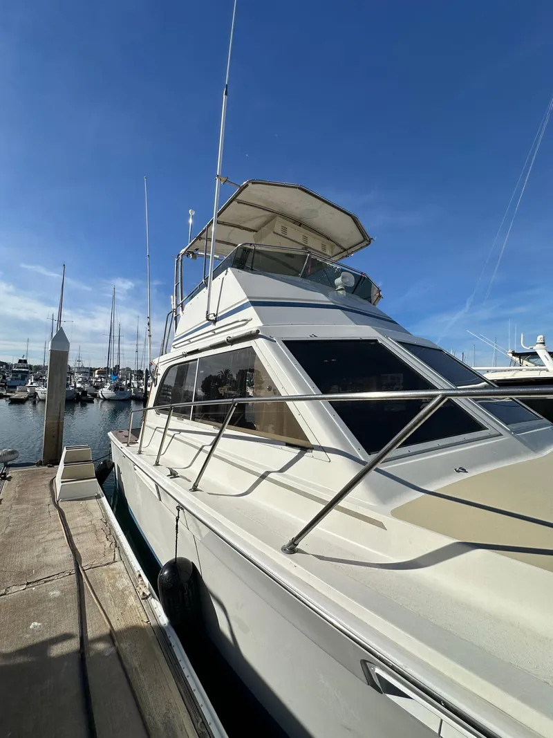 Slide: The Image of 1985 Egg Harbor 33 Sedan yacht docked at marina under clear blue sky. - 4