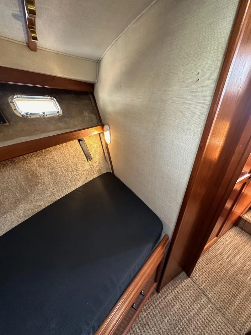 Slide: The Image of 1985 Egg Harbor 33 Sedan cabin interior with cozy bed and wooden accents. - 40