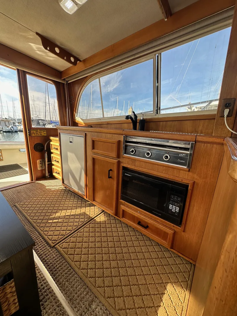 Slide: The Image of 1985 Egg Harbor 33 Sedan interior with kitchenette and wood cabinetry. - 46