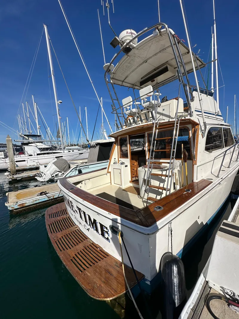 Slide: The Image of 1985 Egg Harbor 33 Sedan yacht docked at marina, clear blue sky. - 6