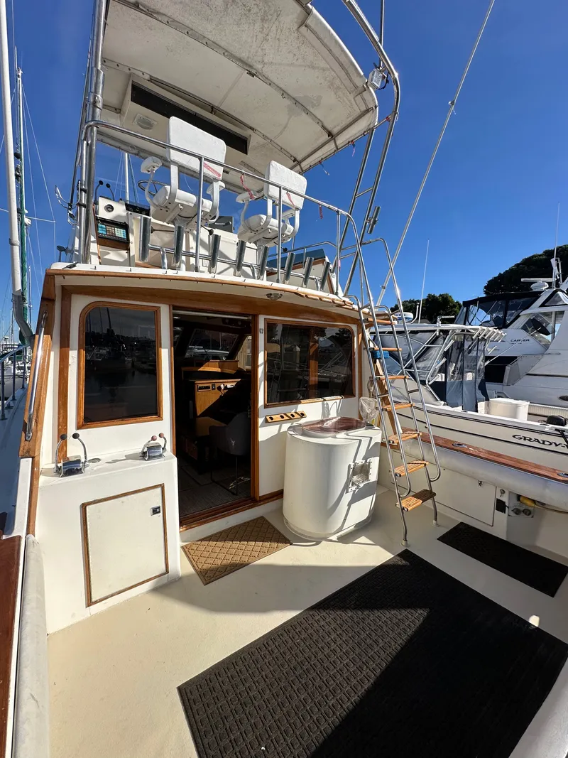 Slide: The Image of 1985 Egg Harbor 33 Sedan boat with spacious deck and upper helm. - 9