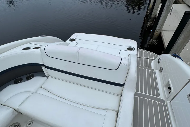Slide: The Image of 2018 Formula 310SS boat with white seating and cup holders by the water. - 10