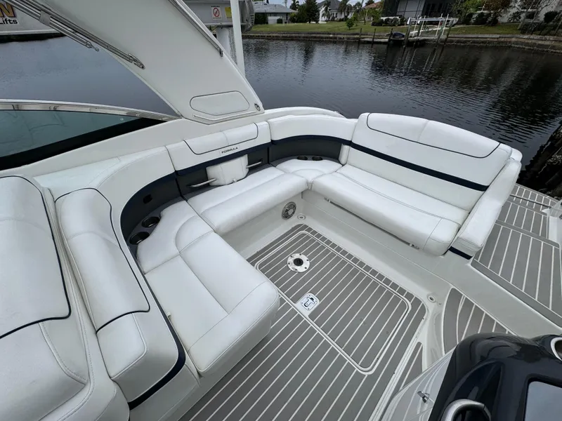 Slide: The Image of Luxurious seating on 2018 Formula 310SS boat, featuring sleek white upholstery and waterfront view. - 11