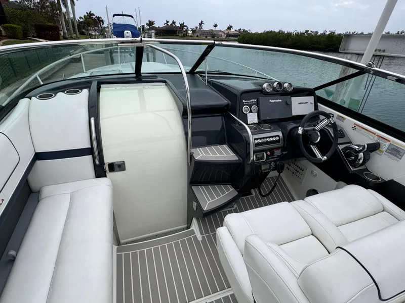 Slide: The Image of 2018 Formula 310SS boat interior with sleek white seating and modern dashboard. - 12