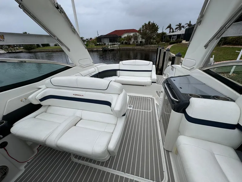 Slide: The Image of 2018 Formula 310SS boat interior with white seating and sleek design. - 13