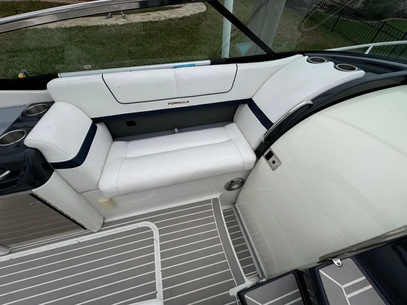 Slide: The Image of 2018 Formula 310SS boat interior with white seating and striped flooring. - 14