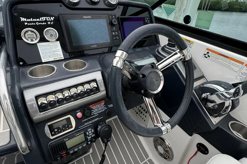 Slide: The Image of 2018 Formula 310SS boat dashboard with steering wheel and navigation controls. - 21