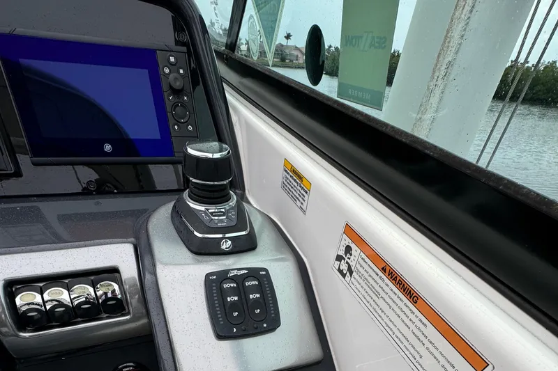 Slide: The Image of 2018 Formula 310SS boat cockpit with control panel and navigation screen. - 23