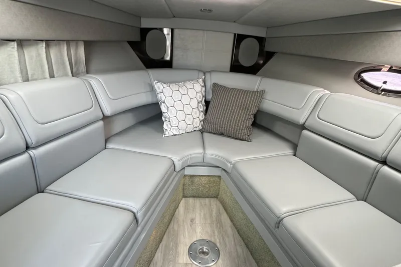 Slide: The Image of 2018 Formula 310SS boat interior with gray seating and decorative pillows. - 26
