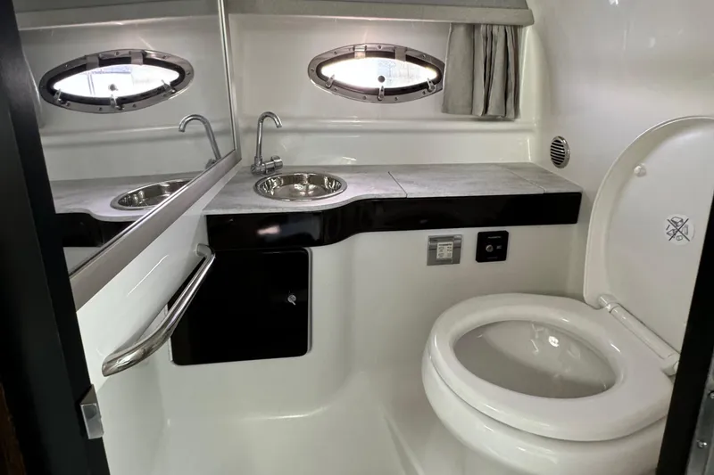 Slide: The Image of 2018 Formula 310SS boat bathroom with sink, mirror, and toilet. - 29