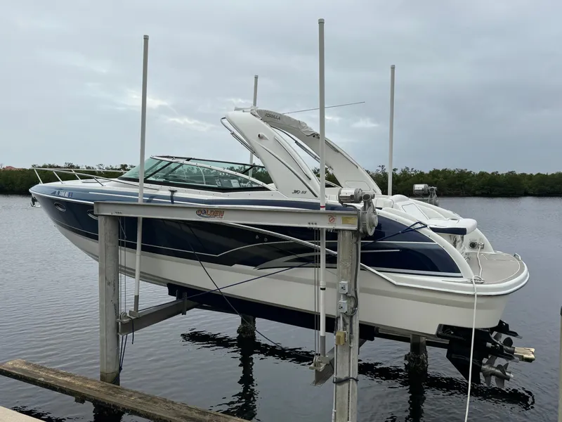 Slide: The Image of 2018 Formula 310SS boat on lift by water, overcast sky. - 3
