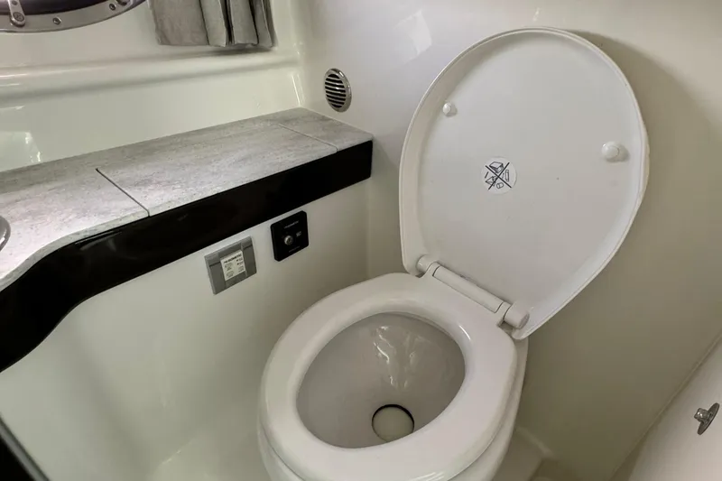 Slide: The Image of 2018 Formula 310SS boat bathroom with modern toilet and countertop. - 30