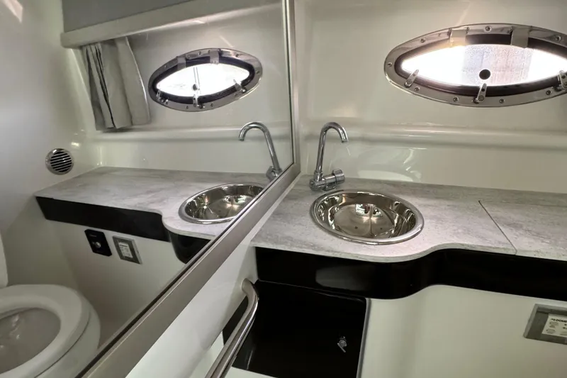 Slide: The Image of 2018 Formula 310SS boat bathroom with modern sink and mirror. - 31