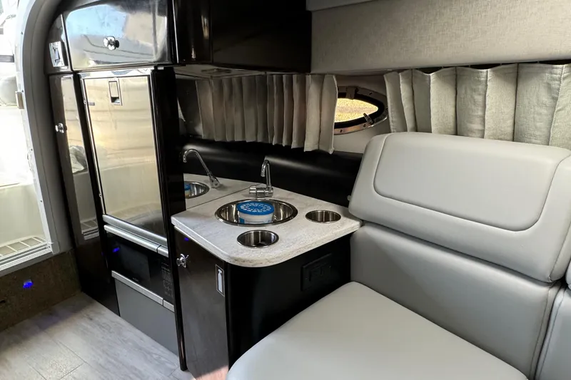 Slide: The Image of 2018 Formula 310SS interior with kitchenette and seating area. - 32
