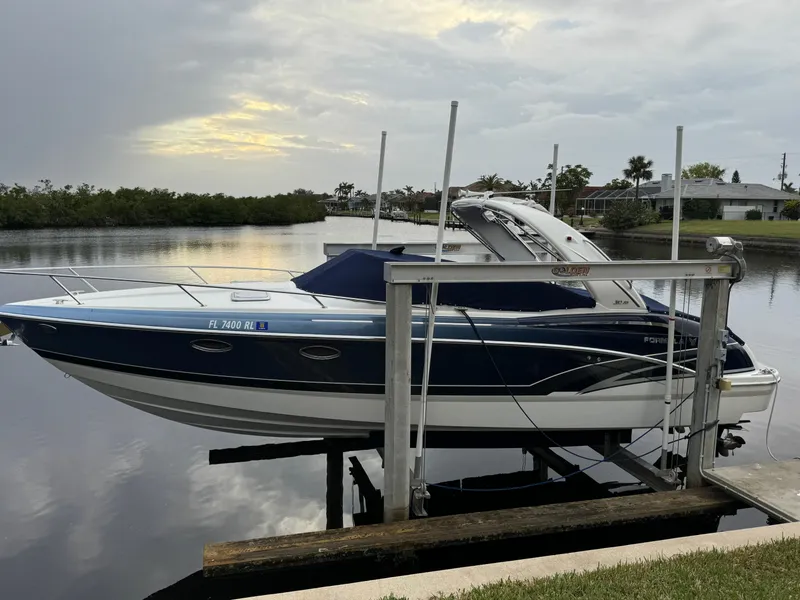 Slide: The Image of 2018 Formula 310SS boat docked by a serene waterfront at sunset. - 4