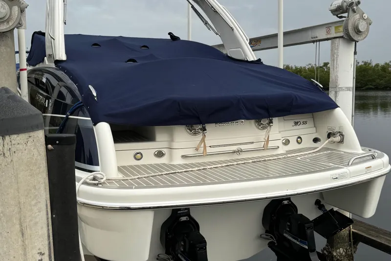 Slide: The Image of 2018 Formula 310SS boat docked, covered with a navy blue tarp. - 5