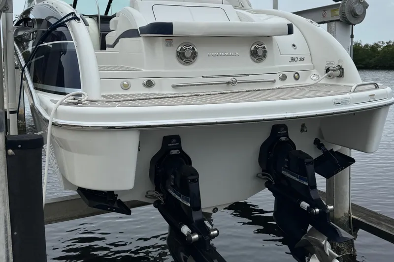 Slide: The Image of 2018 Formula 310SS boat on lift, showcasing dual outboard motors. - 7