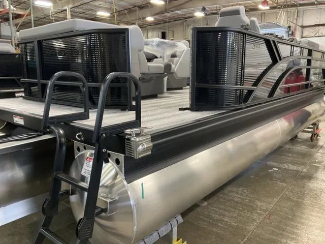 Slide: The Image of 2025 Bennington 23 SL pontoon boat in a warehouse setting. - 10