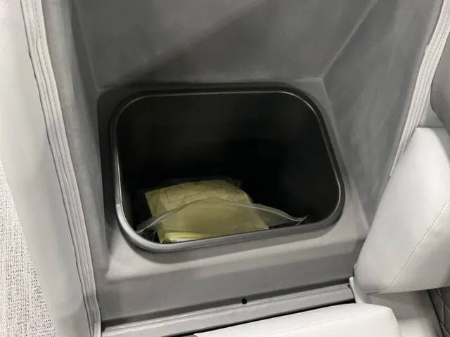 Slide: The Image of Storage compartment in 2025 Bennington 23 SL boat with items inside. - 11