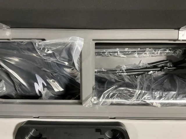 Slide: The Image of Storage compartment of 2025 Bennington 23 SL boat with packaged accessories. - 12