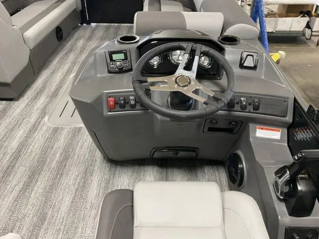 Slide: The Image of 2025 Bennington 23 SL boat dashboard with steering wheel and controls. - 4