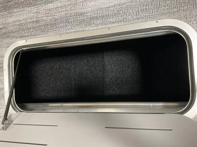 Slide: The Image of Storage compartment of 2025 Bennington 23 SL boat, open and empty. - 9