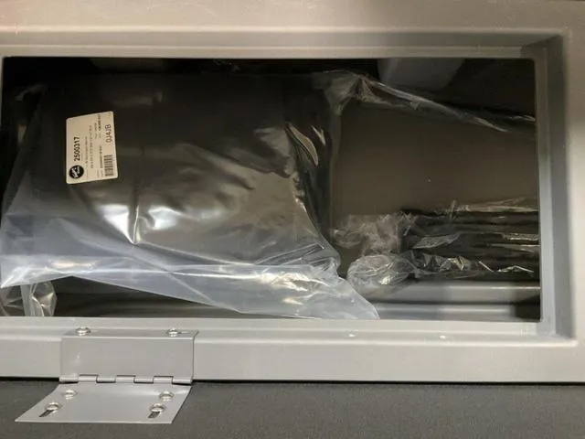 Slide: The Image of Storage compartment of 2025 Bennington 23 SL boat with packaged items inside. - 10