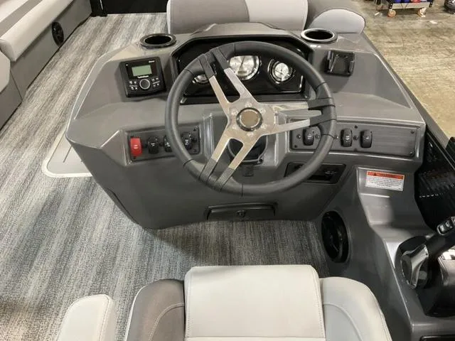 Slide: The Image of 2025 Bennington 23 SL boat dashboard with steering wheel and control panel. - 4