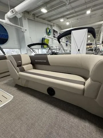 Slide: The Image of 2025 Bennington 23 SL pontoon boat in showroom, featuring spacious seating and modern design. - 10