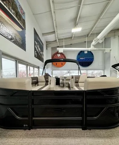 Slide: The Image of 2025 Bennington 23 SL boat interior with beige seating in showroom. - 12