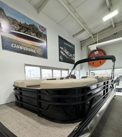 Slide: The Image of 2025 Bennington 23 SL boat interior with beige seating and a sleek black table. - 15
