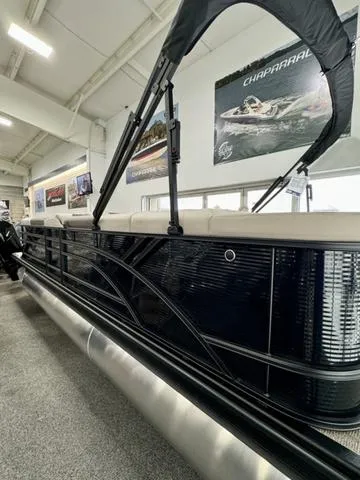 Slide: The Image of 2025 Bennington 23 SL pontoon boat interior in showroom, featuring plush seating and modern design. - 16