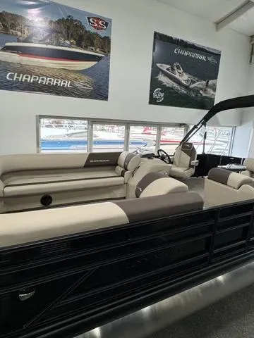 Slide: The Image of 2025 Bennington 23 SL pontoon boat in showroom, sleek black design. - 3