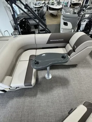 Slide: The Image of 2025 Bennington 23 SL pontoon boat in showroom with luxury seating. - 7