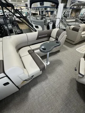 Slide: The Image of 2025 Bennington 23 SL pontoon boat displayed in a showroom with Chaparral posters. - 9
